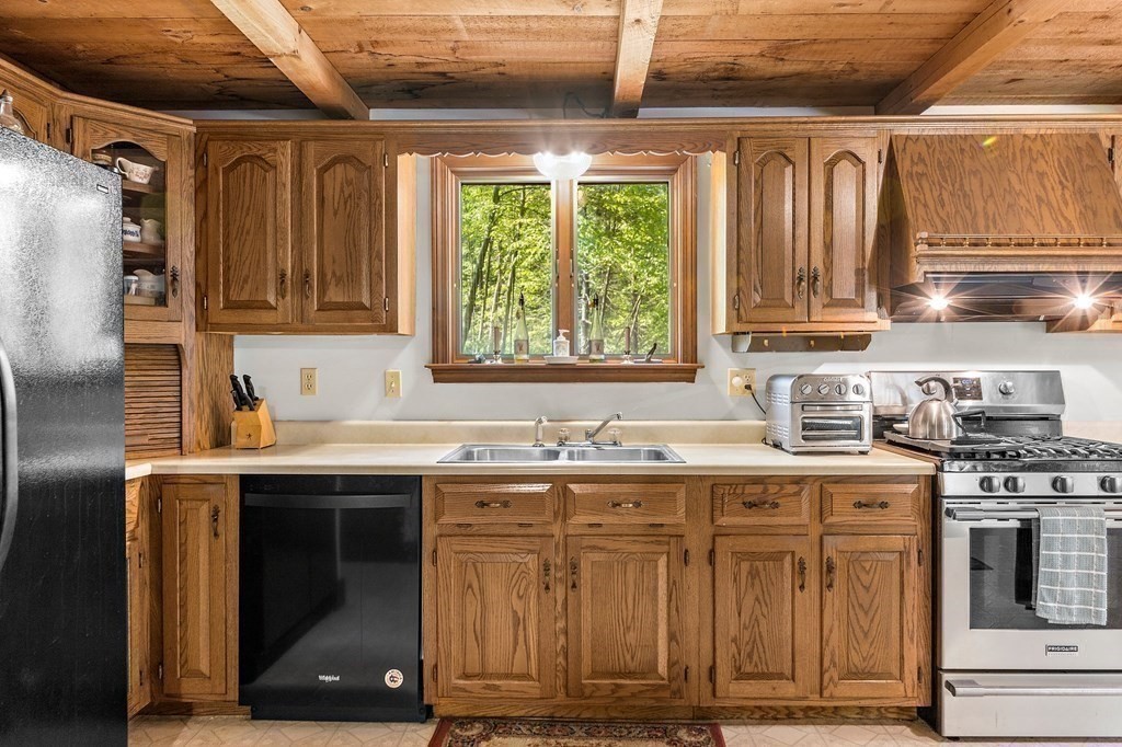 41 Baker Road Salisbury, MA 01952 - Photo 8 of 29 a kitchen with stainless steel appliances granite countertop a sink a stove and a refrigerator
