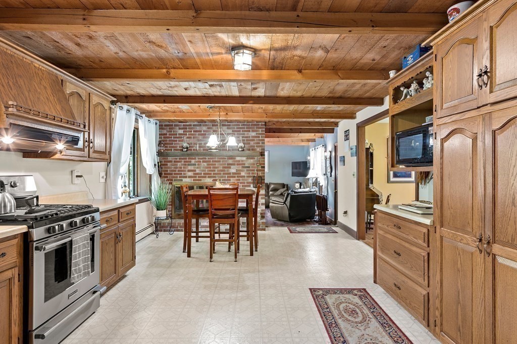 41 Baker Road Salisbury, MA 01952 - Photo 10 of 29 a kitchen with stainless steel appliances granite countertop a stove and a refrigerator