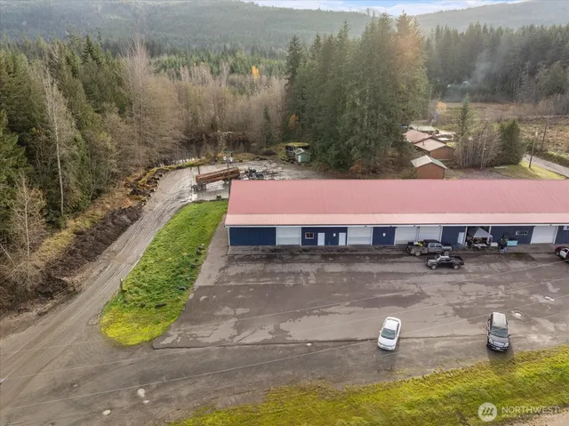 a view of a lake with lawn chairs under an umbrella