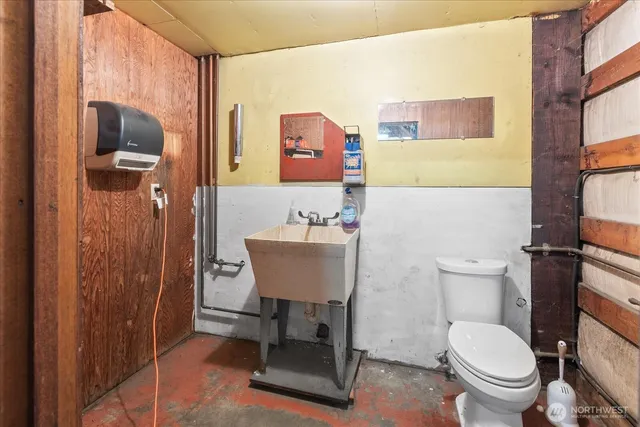 a bathroom with a toilet a sink and mirror