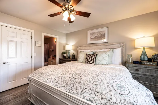 a bedroom with a large bed and a chandelier
