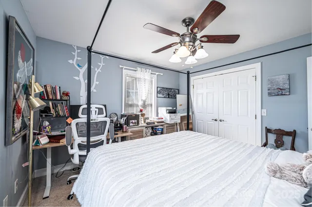 a bedroom with a bed and ceiling fan