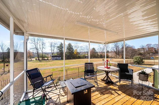 a living room with patio furniture and a floor to ceiling window