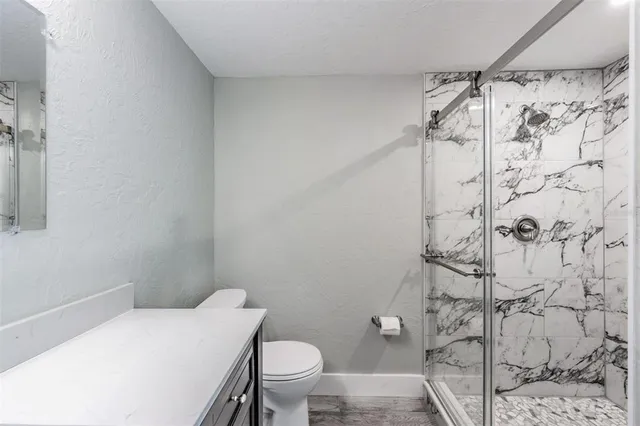 a bathroom with a toilet and shower