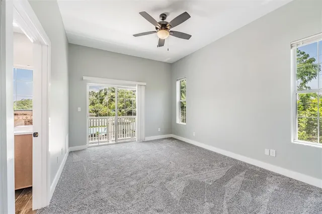 a view of a livingroom with a ceiling fan and window