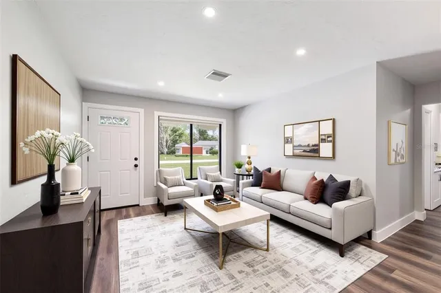 a living room with furniture a rug and a window