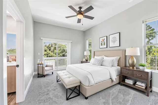 a bedroom with a bed and a large window