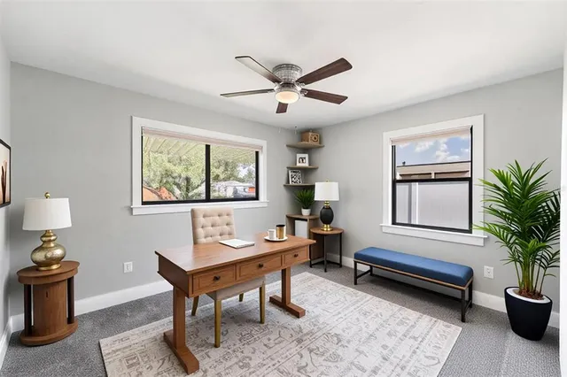 a living room with furniture potted plant and window