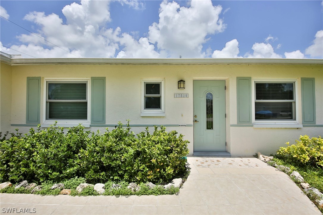 17520 Lebanon Road Fort Myers, FL 33967 - Photo 2 of 15 a view of a house with a flower garden