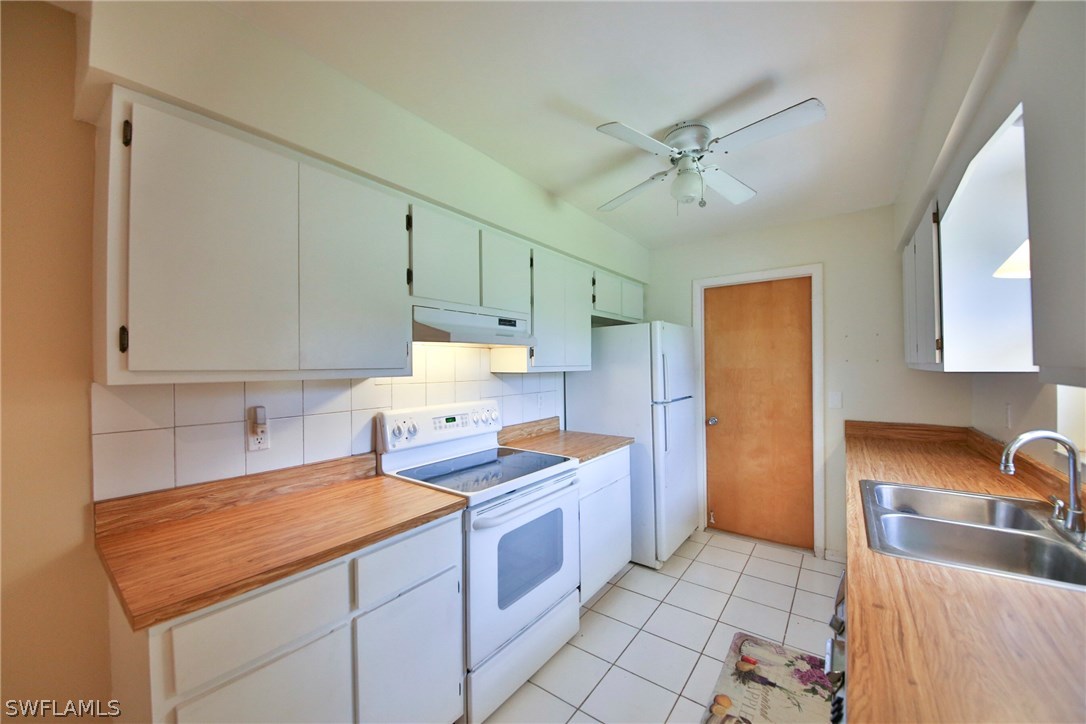17520 Lebanon Road Fort Myers, FL 33967 - Photo 6 of 15 a kitchen with stainless steel appliances granite countertop a sink and cabinets