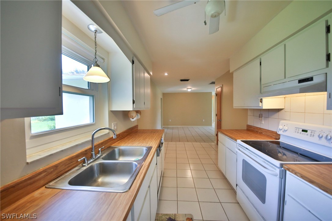 17520 Lebanon Road Fort Myers, FL 33967 - Photo 7 of 15 a kitchen with a sink and a stove top oven