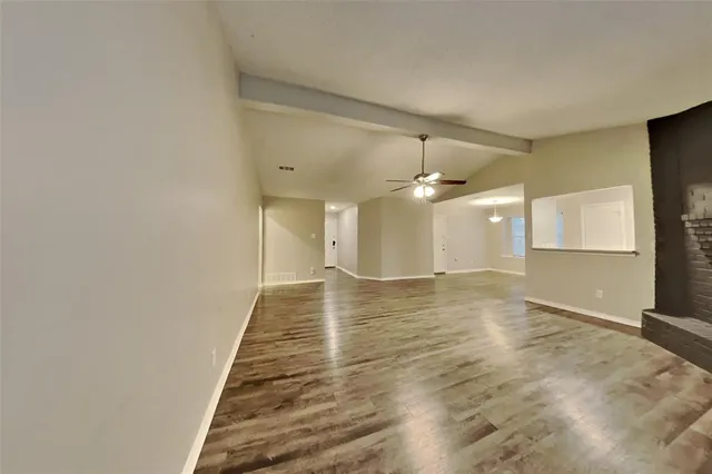 a view of a room with wooden floor