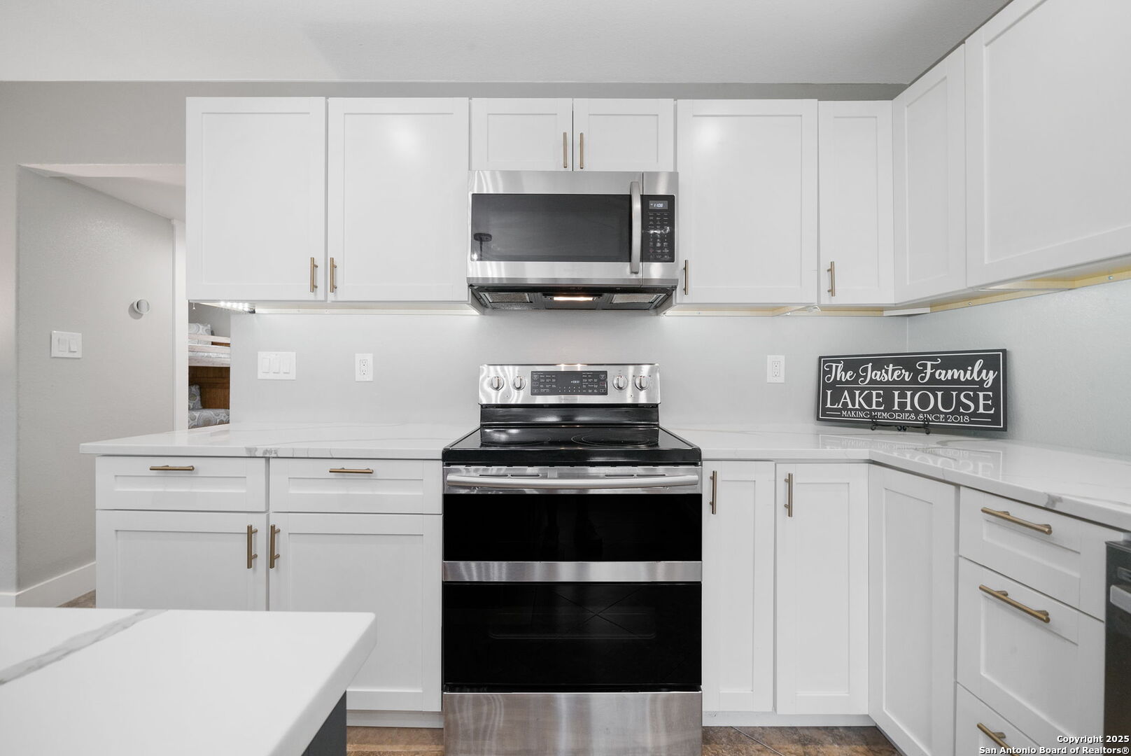 1500 Ranch Road 1431, Unit 103 Kingsland, TX 78639 - Photo 13 of 29 a kitchen with stainless steel appliances a stove and white cabinets