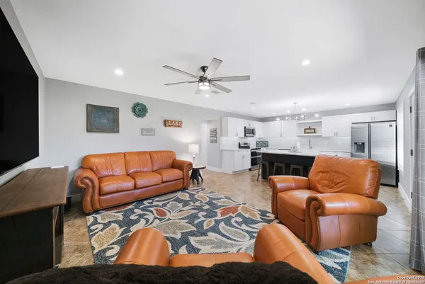 a living room with furniture a rug and a flat screen tv