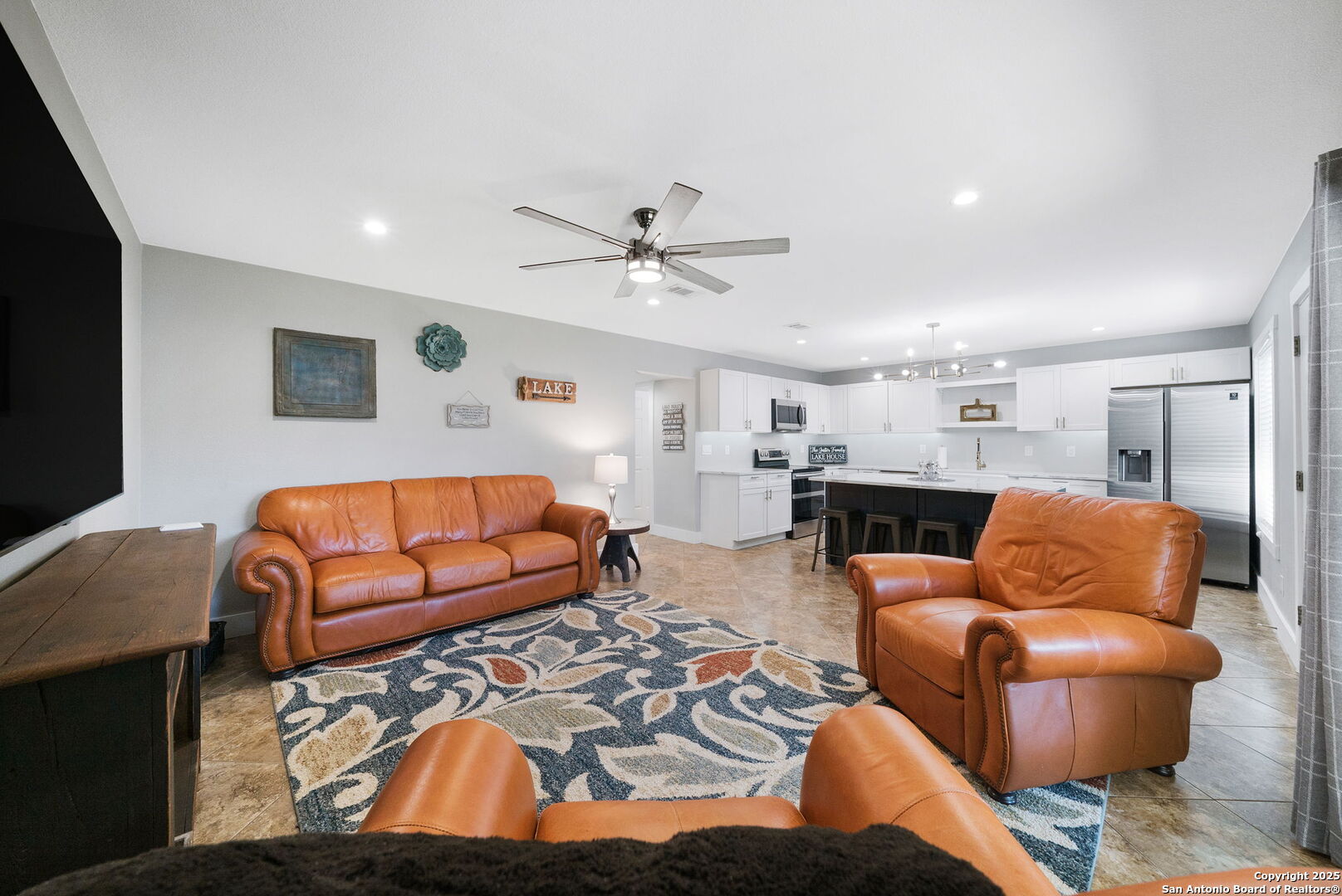 1500 Ranch Road 1431, Unit 103 Kingsland, TX 78639 - Photo 15 of 29 a living room with furniture kitchen view and a flat screen tv