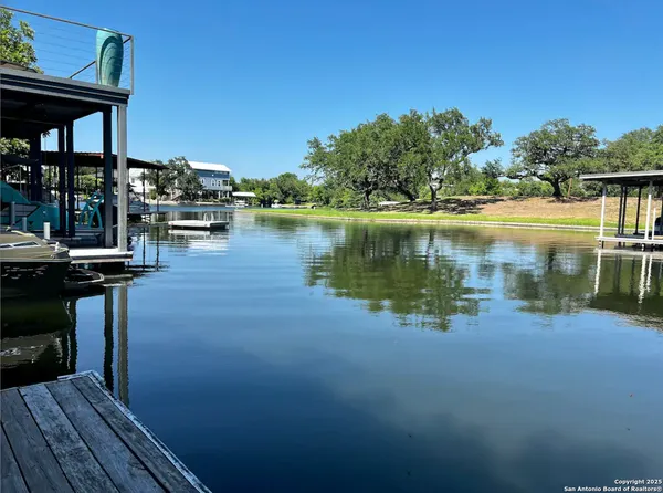a view of a lake with boats and deck