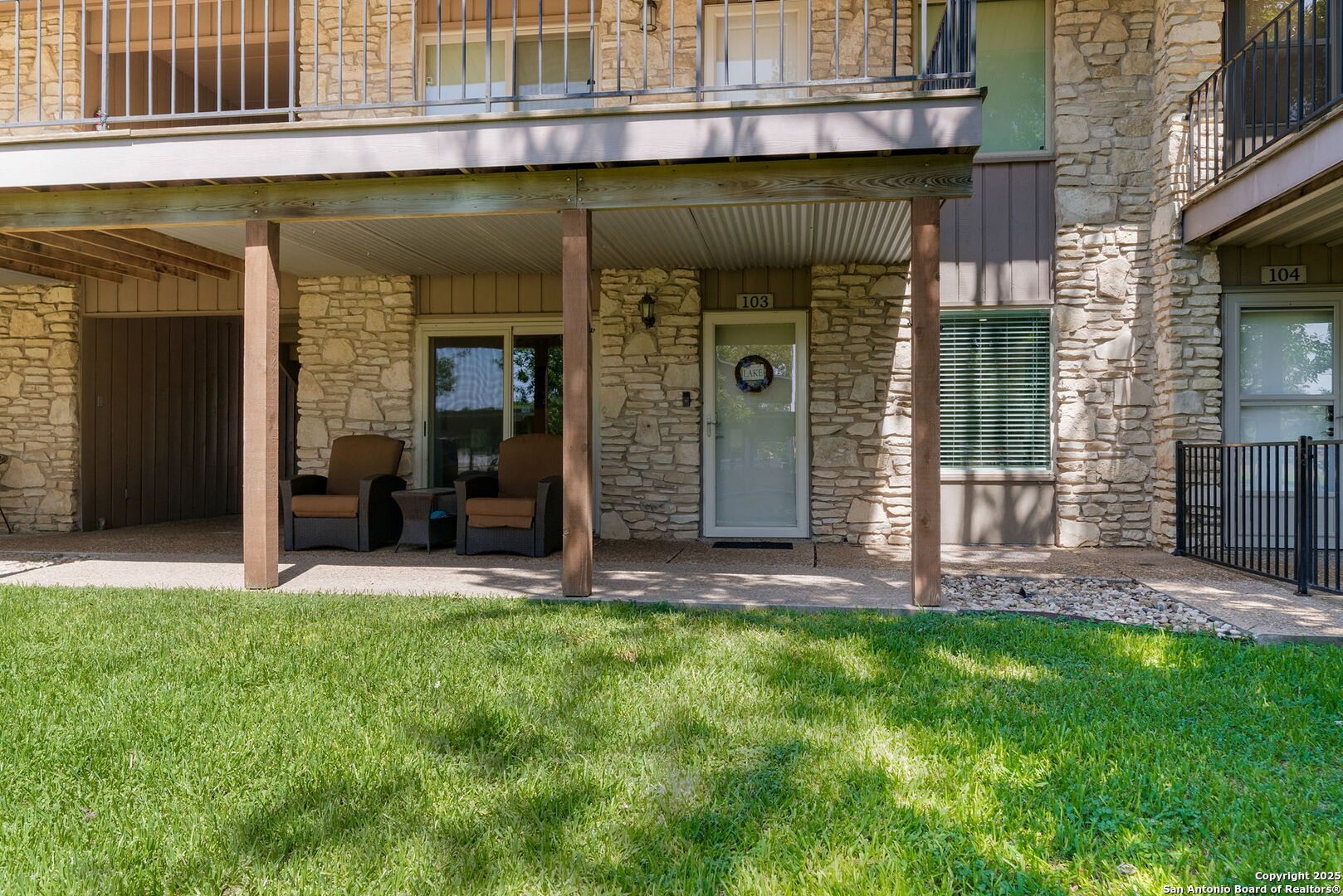1500 Ranch Road 1431, Unit 103 Kingsland, TX 78639 - Photo 28 of 29 a view of a front of a house with a large window and a yard