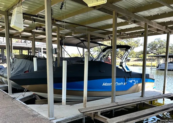 a kitchen with kitchen island granite countertop a sink counter and chairs