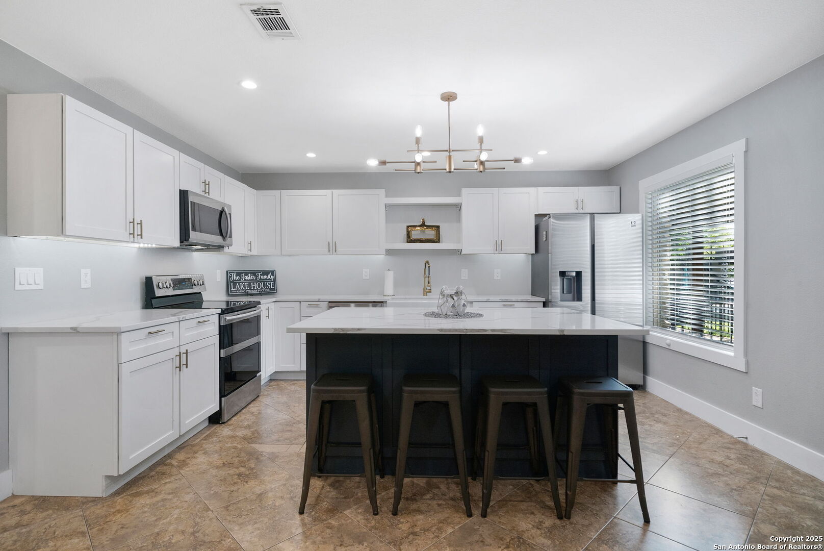 1500 Ranch Road 1431, Unit 103 Kingsland, TX 78639 - Photo 6 of 29 a kitchen with kitchen island granite countertop a sink counter and chairs