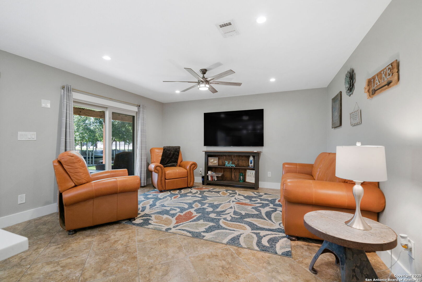 1500 Ranch Road 1431, Unit 103 Kingsland, TX 78639 - Photo 10 of 29 a living room with furniture a ceiling fan and a flat screen tv