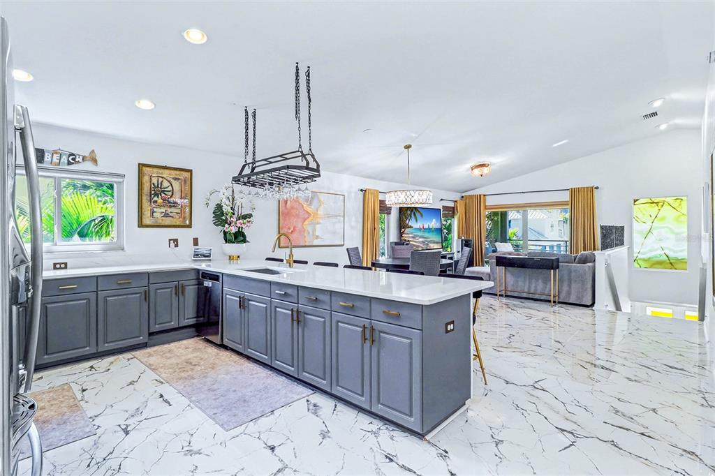 15517 Gulf Boulevard Redington Beach, FL 33708 - Photo 13 of 48 a kitchen with stainless steel appliances kitchen island granite countertop a sink and cabinets