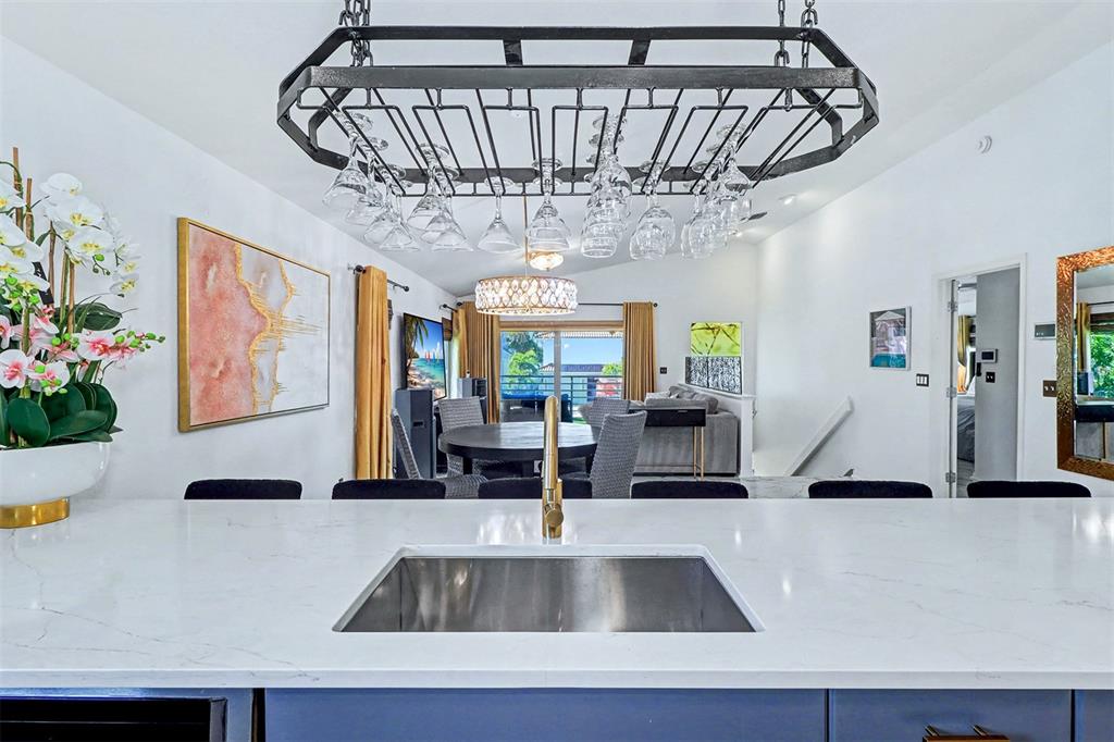 15517 Gulf Boulevard Redington Beach, FL 33708 - Photo 14 of 48 a view of spacious kitchen with a dining table and a chandelier
