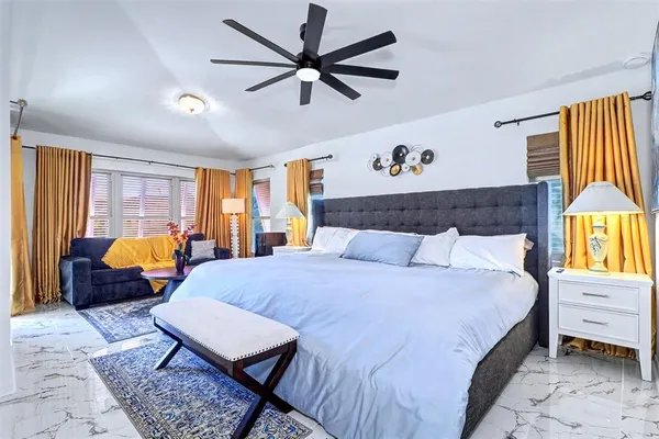 a bed room with a bed window and a couch