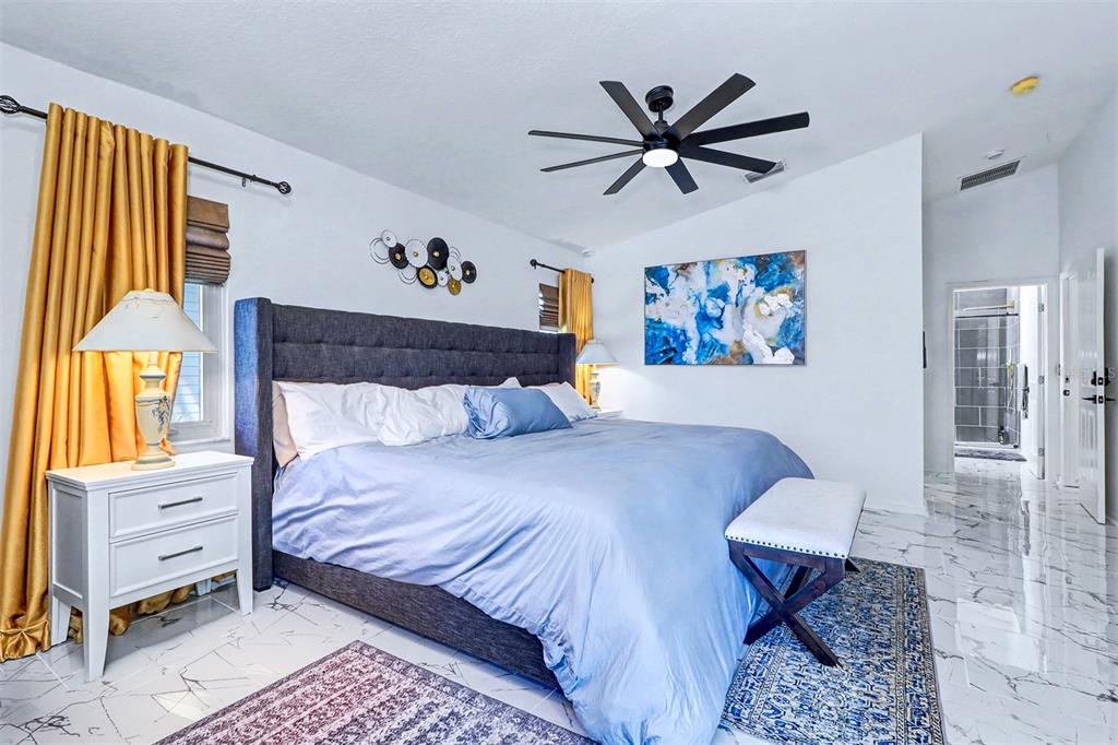 15517 Gulf Boulevard Redington Beach, FL 33708 - Photo 18 of 48 a bedroom with a bed and a painting on the wall