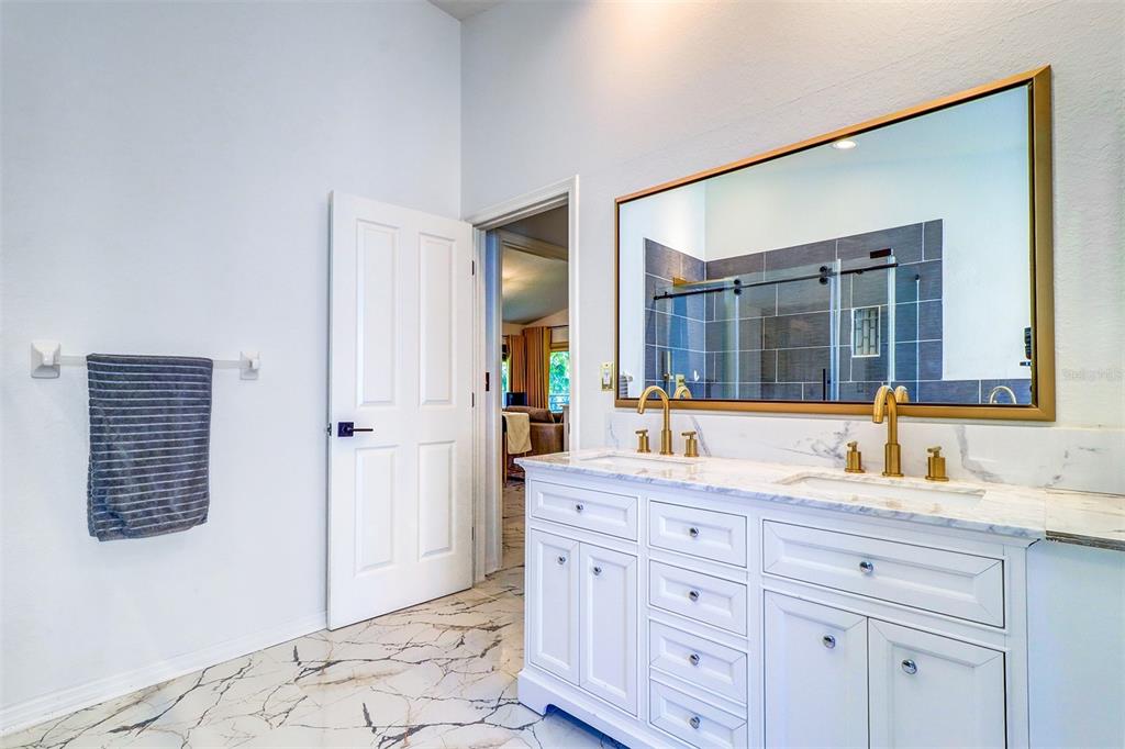 15517 Gulf Boulevard Redington Beach, FL 33708 - Photo 20 of 48 a bathroom with a granite countertop sink and a mirror