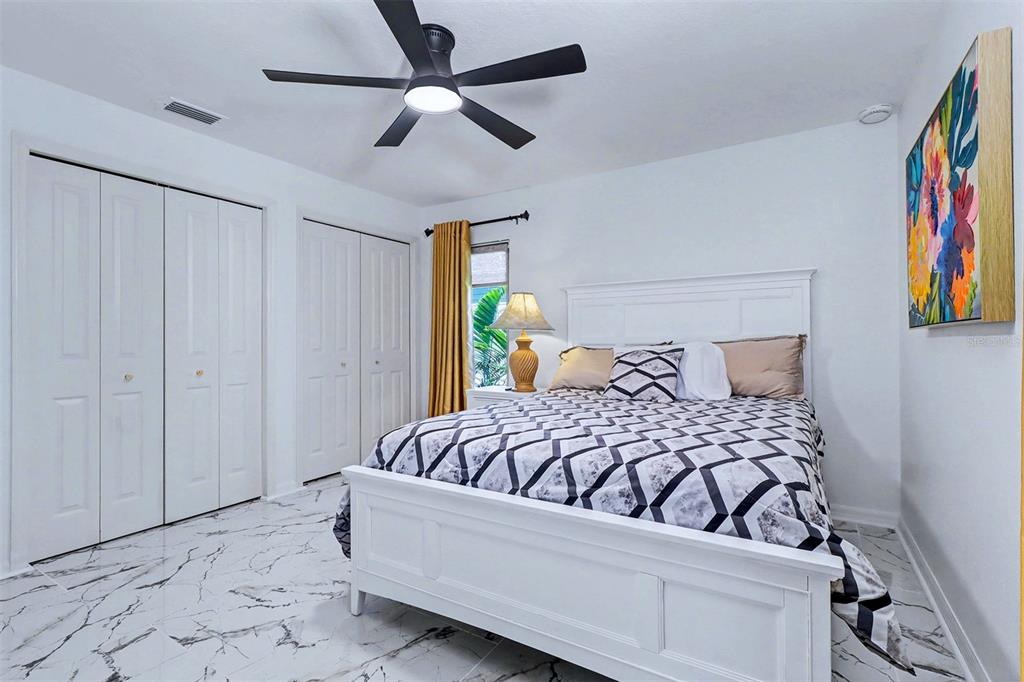 15517 Gulf Boulevard Redington Beach, FL 33708 - Photo 23 of 48 a bedroom with a bed and a painting on the wall