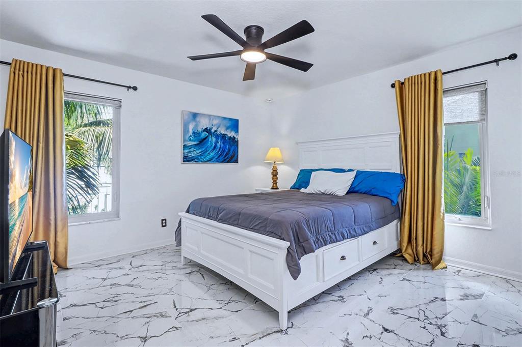 15517 Gulf Boulevard Redington Beach, FL 33708 - Photo 24 of 48 a bedroom with a bed and a large window