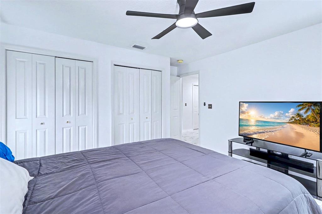 15517 Gulf Boulevard Redington Beach, FL 33708 - Photo 25 of 48 a bedroom with a bed and a flat screen tv