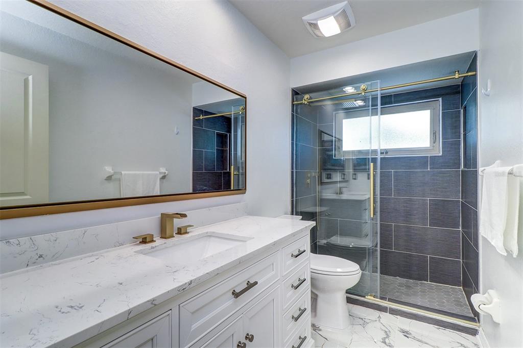 15517 Gulf Boulevard Redington Beach, FL 33708 - Photo 26 of 48 a bathroom with a sink toilet and shower