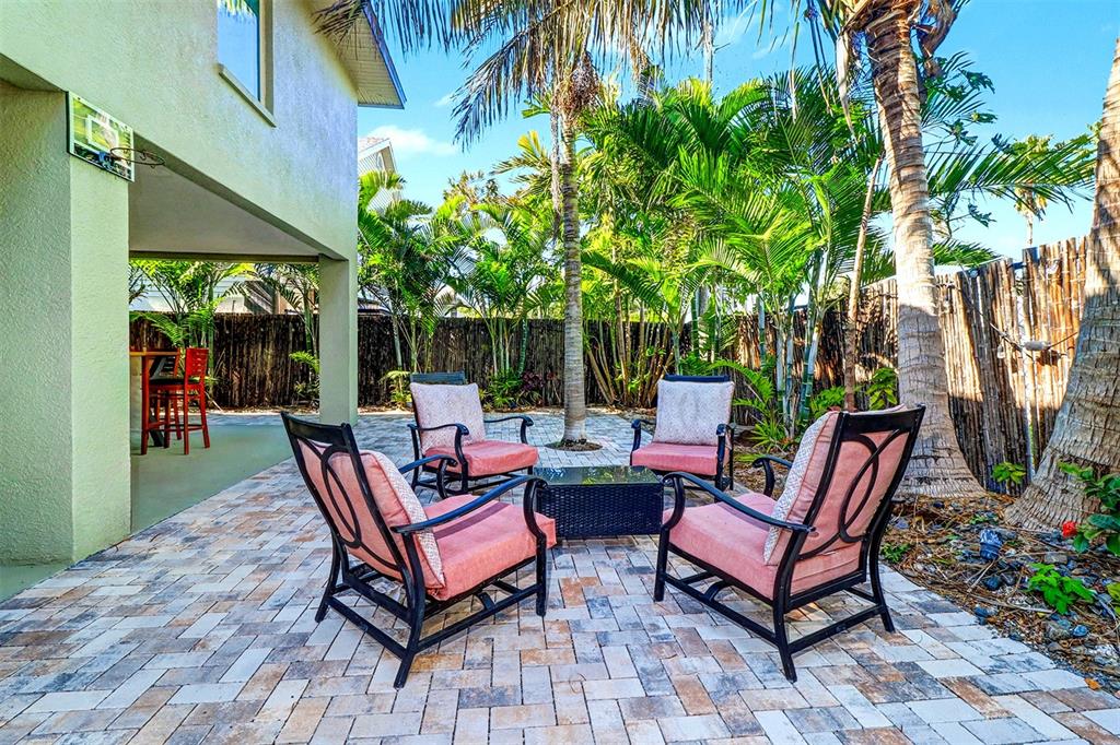 15517 Gulf Boulevard Redington Beach, FL 33708 - Photo 30 of 48 a backyard of a house with fire pit table and chairs