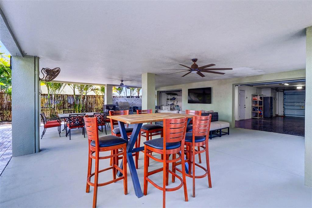 15517 Gulf Boulevard Redington Beach, FL 33708 - Photo 33 of 48 a dining room with furniture and a floor to ceiling window