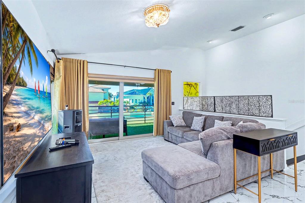 15517 Gulf Boulevard Redington Beach, FL 33708 - Photo 6 of 48 a living room with furniture and a flat screen tv