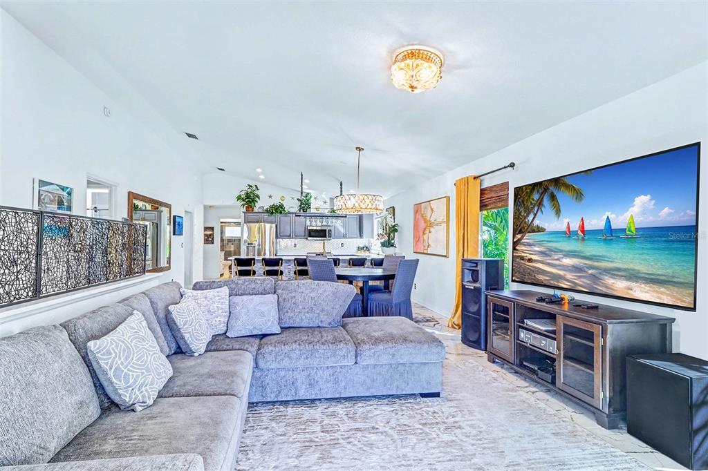 15517 Gulf Boulevard Redington Beach, FL 33708 - Photo 8 of 48 a living room with fireplace furniture and a flat screen tv