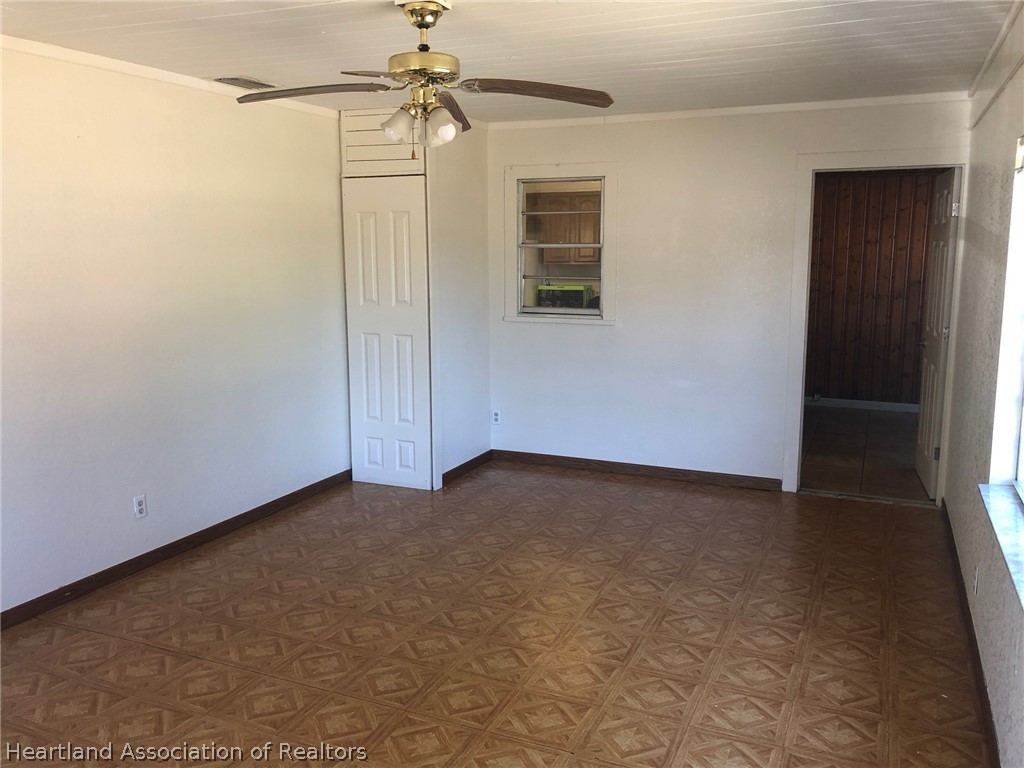313 Heard Bridge Road Wauchula, FL 33873 - Photo 15 of 20 en empty room with windows and fan