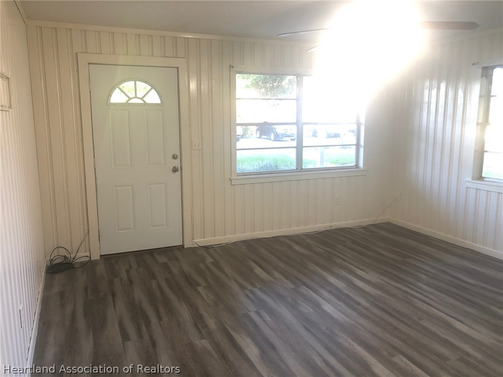 313 Heard Bridge Road Wauchula, FL 33873 - Photo 7 of 20 an empty room with wooden floor and windows