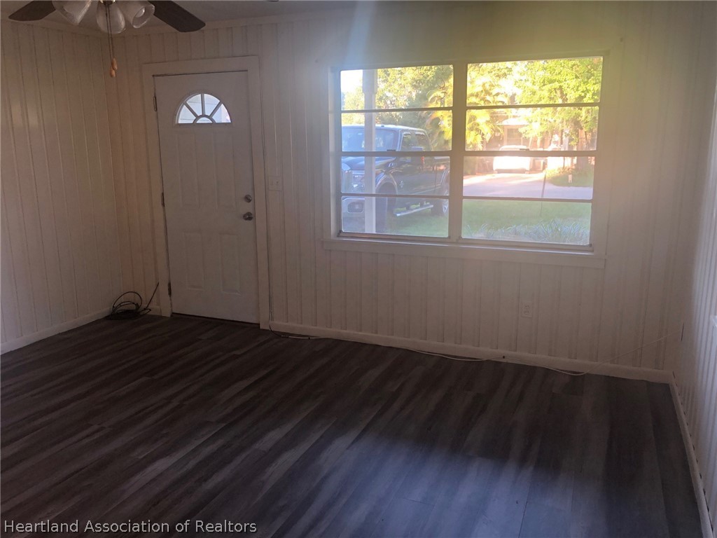 313 Heard Bridge Road Wauchula, FL 33873 - Photo 9 of 20 a view of empty room with wooden floor and fan