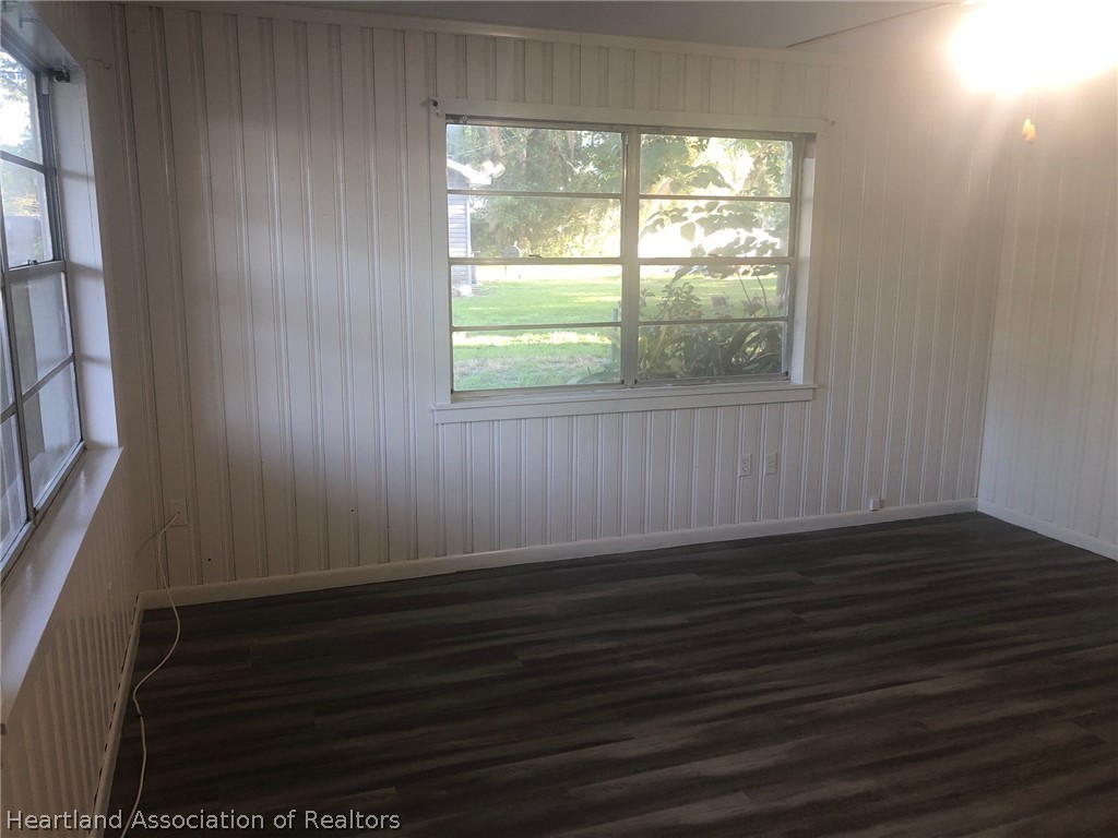 313 Heard Bridge Road Wauchula, FL 33873 - Photo 10 of 20 a view of an empty room with wooden floor and a window
