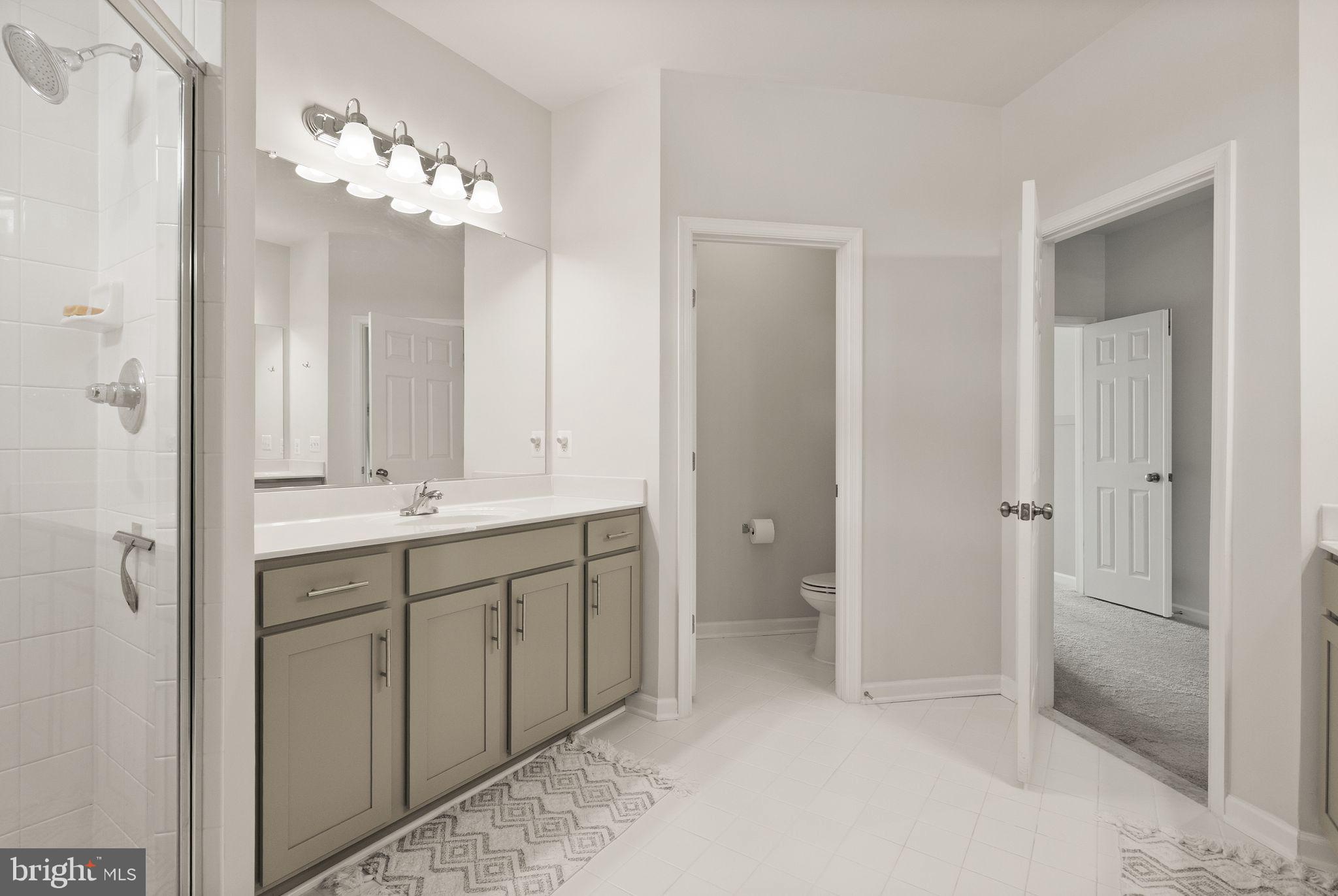 131 Interlace Way Stephenson, VA 22656 - Photo 29 of 71 a spacious bathroom with a double vanity sink mirror and a shower