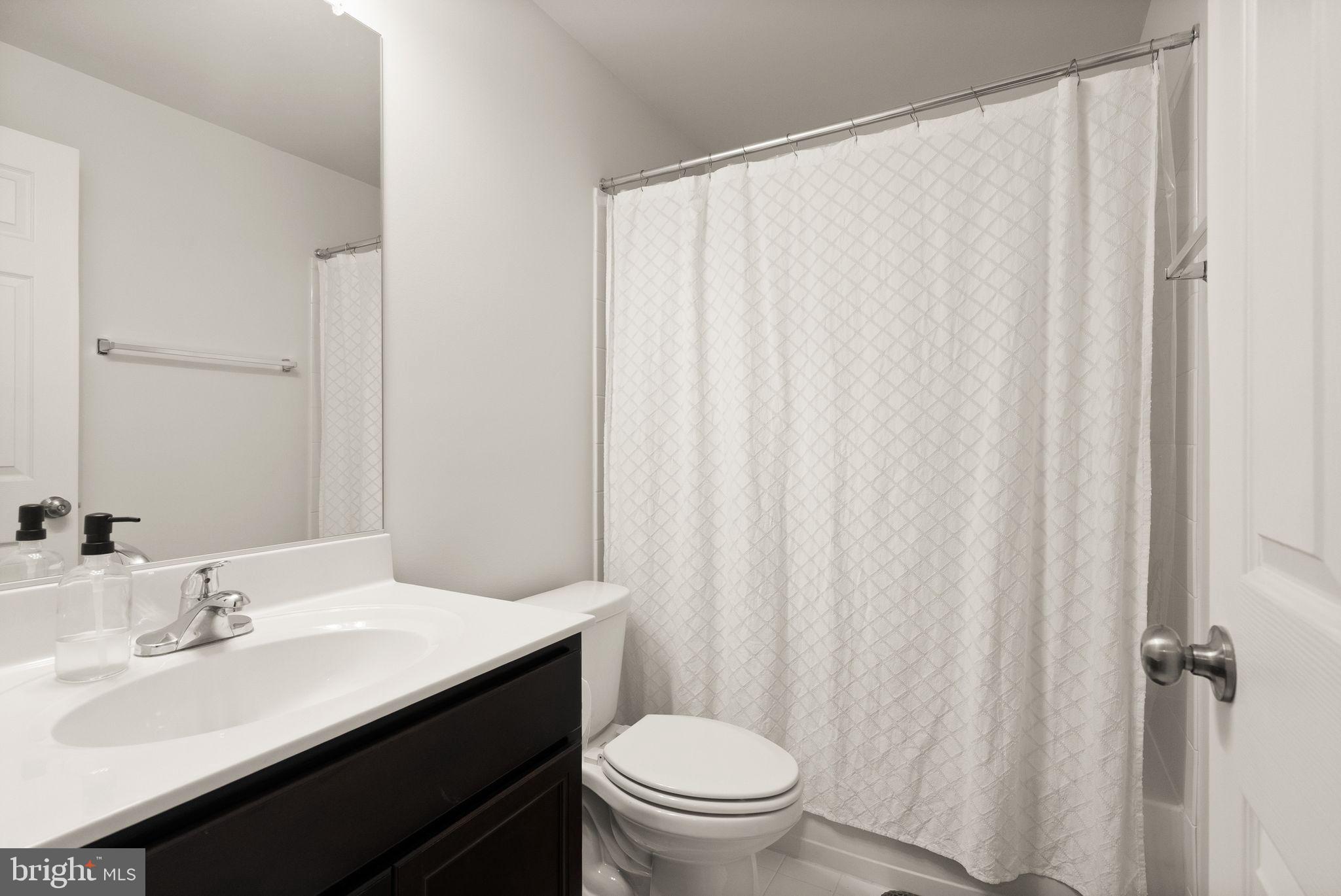 131 Interlace Way Stephenson, VA 22656 - Photo 46 of 71 a bathroom with a sink a toilet and shower curtain