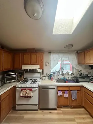 a kitchen with stainless steel appliances a stove a sink and a microwave