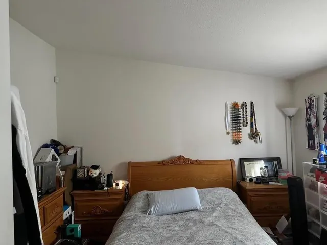 a bedroom with furniture and a wooden floor