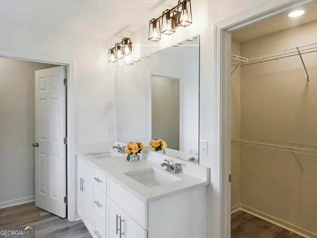 a bathroom with a sink vanity and a mirror