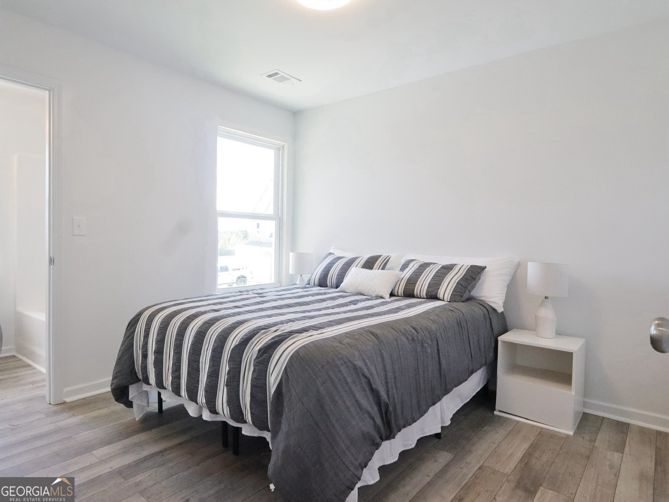 157 Pinto Lane Fairmount, GA 30139 - Photo 14 of 19 a bedroom with a bed and wooden floor