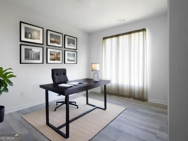a workspace with furniture window and wooden floor