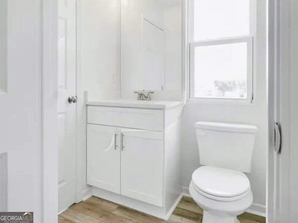 a bathroom with a toilet a sink and a window