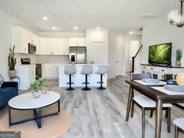 a living room with furniture and a flat screen tv